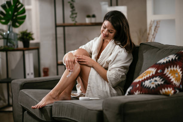 istock Beautiful woman applying body cream. 1299922458