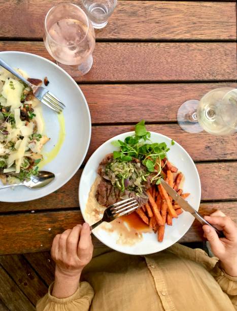 istock Pub Dinner Meal Steak Chips Salad Pasta Wine 1299923510