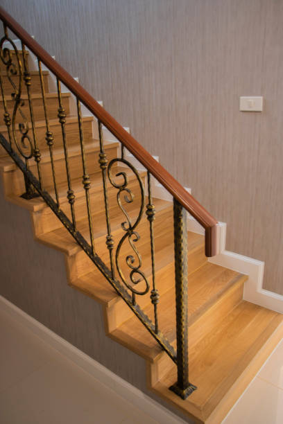 istock Staircase, wooden floor and black iron rail. 1299924096
