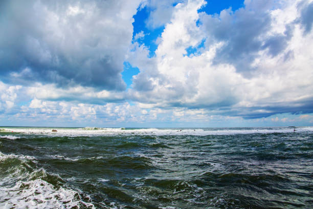 Beach in Tel Aviv. Sunset. Windy cloudy day in Israel. Raging storm in the Mediterranean. Powerful winter surf takes off with snow-white foam.
