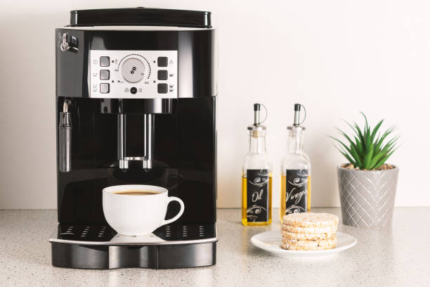 istock Modern espresso coffee machine with a cup in interior of kitchen closeup. 1299925276