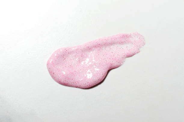istock Pink cosmetics smear with glitter on the white background 1299925326