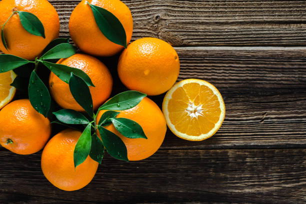 istock Farm fresh fruit of orange, top view. Ripe oranges on table. 1299925538