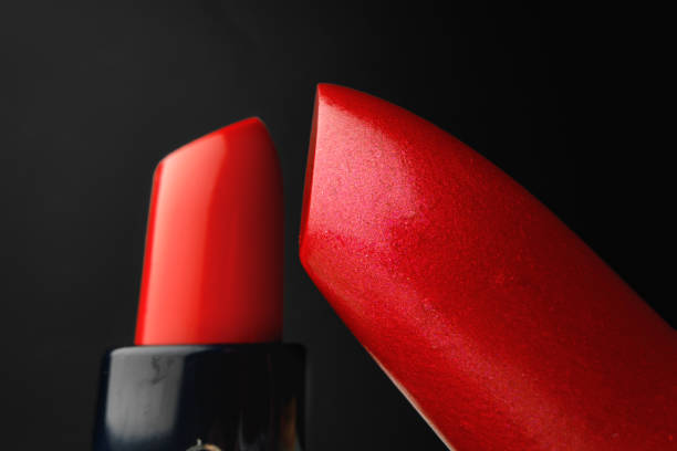 istock Red lipstick on black background close up 1299925554