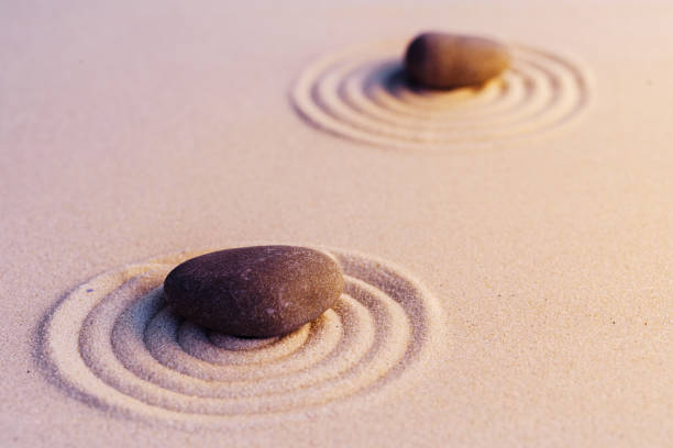 istock Zen garden stones on sand with ornament 1299926366