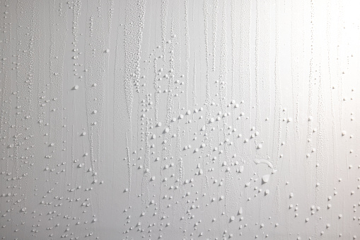 Abstract background pattern of refrigerator panel with melting drops of frozen water falling down