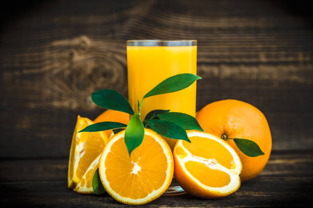 istock Fresh orange and squeezed orange juice on table 1299927615