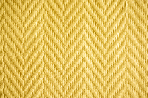 Abstract background pattern of yellow relief wallpaper with diagonal slanted patterns