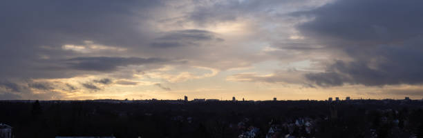 istock Cloudscape with moody yellow and blue sky and dark clouds for background or sky replacement or cityscape over Brussels, capital of Europe 1299927822