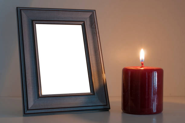 Red funeral candle next to a blank wood photo frame Red funeral candle next to a blank wood photo frame funeral parlor photos stock pictures, royalty-free photos & images