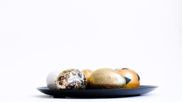 Eggs put on plate. Easter golden decorated eggs isolated on white background. Minimal easter concept. Happy Easter card
