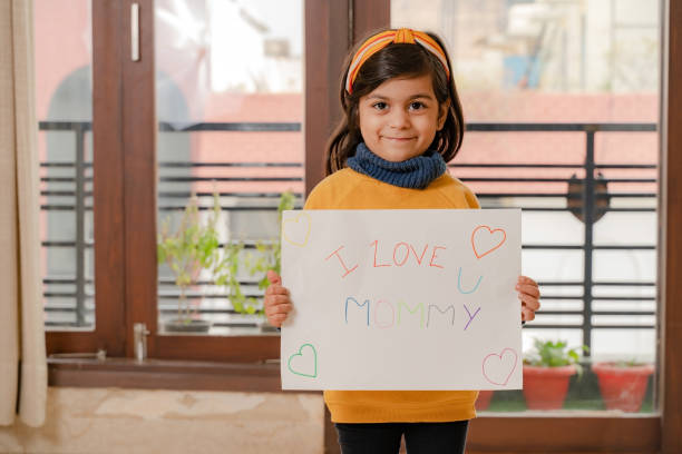 istock Small girl holding mother's day poster 1299931089