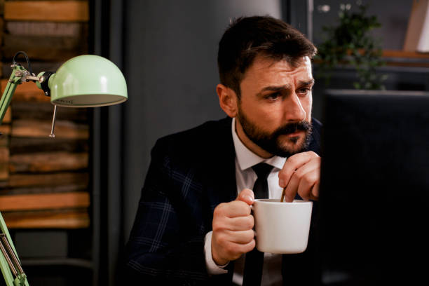 istock Young businessman drinking coffee in his office. 1299931109