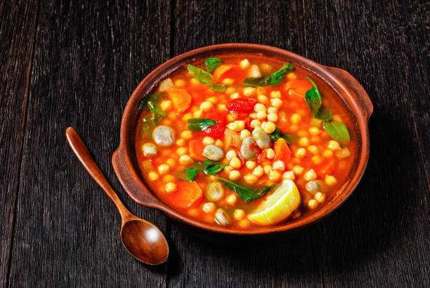 istock chickpea and green broad bean Moroccan soup in an earthenware bowl on a rustic wooden table 1299931114