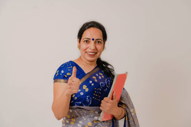 teacher in saree standing poses in studio - women professor mature adult human face imagens e fotografias de stock