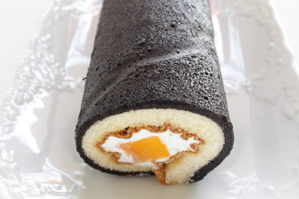 istock Mango and black color swiss roll on dish 1299931716
