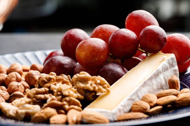 Close up photo of nuts and grapes on plate