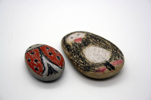 istock Drawing on sea stones. Classes with children. 1299932188