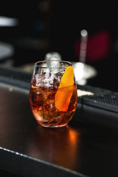 istock refreshing red coctail with orange isolated on a bar background 1299932605