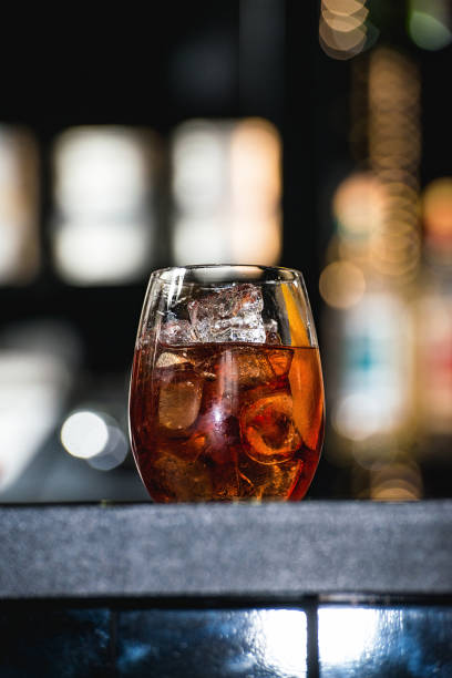 istock refreshing red coctail with orange isolated on a bar background 1299932690