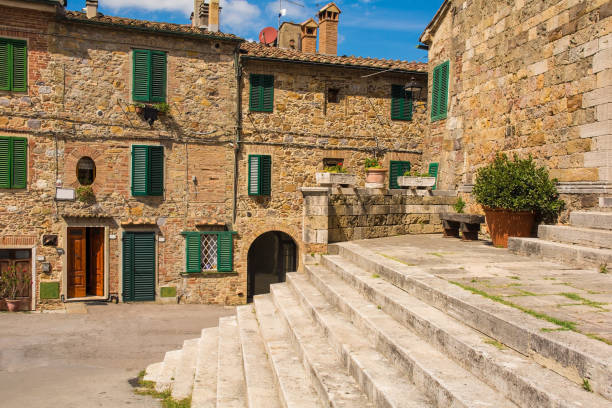 Church Steps in Monticiano, Tuscany The steps of the Parish Church in the historic centre of the medieval town of Monticiano in Siena Province, Tuscany, Italy. The church is know as Parrocchia e Chiesa di Santi Giusto e Clemente - Church of Saints Justus and Clements crete senesi stock pictures, royalty-free photos & images