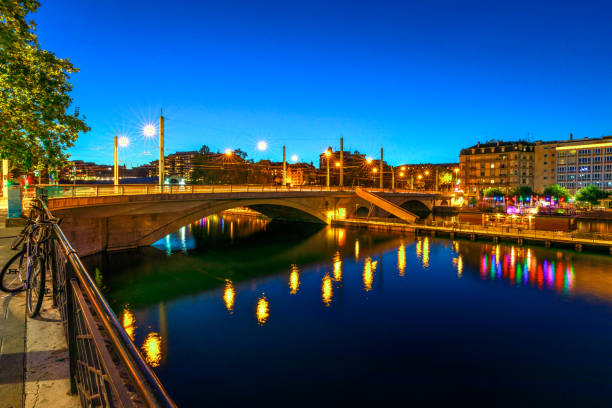 istock Geneva bridge Switzerland by night 1299934950