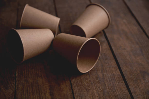 istock ecological kraft paper cups for coffee and tea dark brown on the table 1299935724