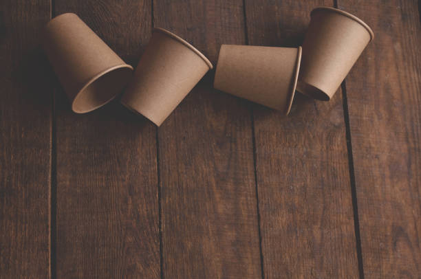 istock ecological kraft paper cups for coffee and tea dark brown on the table 1299935754