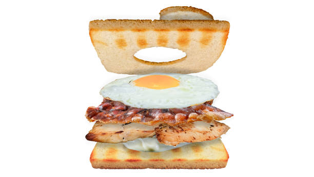 Open sandwich floating with chicken bacon and egg with mayonnaise on white background