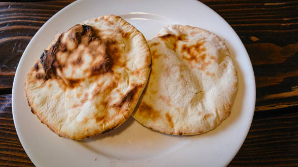 istock Two small bread tortillas stand in a plate on the table 1299936634