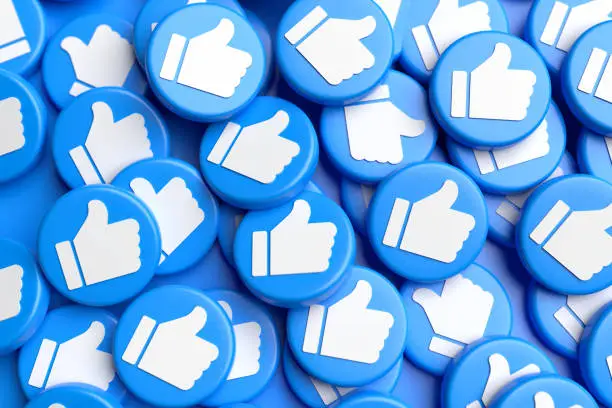 Photo of Many like buttons with white thumbs up on blue on a heap. Social Media Concept. Full frame.