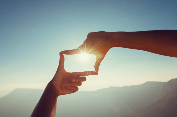 istock close up hand framing looking view sunrise 1299938451