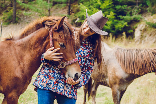 cowgirl with foals - halter imagens e fotografias de stock