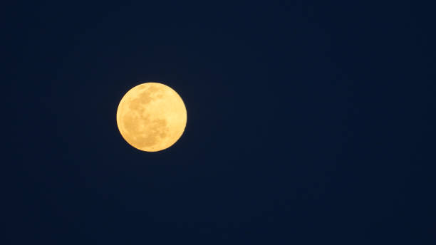 istock Orange night moon in the black background 1299939131
