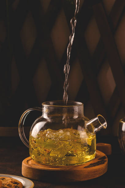 istock Healing linden herbal tea in a teapot on a dark background 1299939995