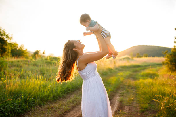 istock Mother and a baby enjoying beautiful sunset 1299940016
