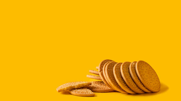 istock Many Marie biscuits  on bright yellow background. Modern cookies concept. 1299940259
