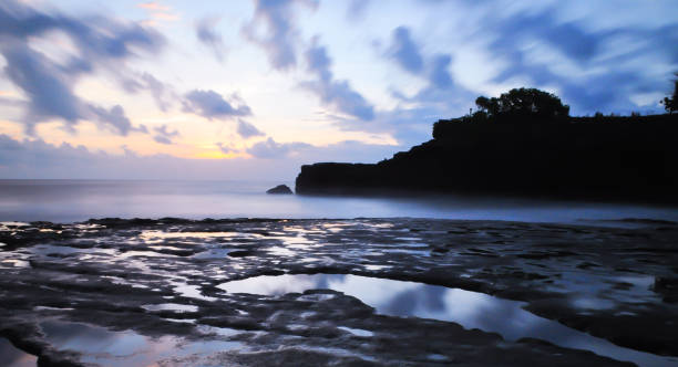 istock Sunsets at the rocky beach 1299940656