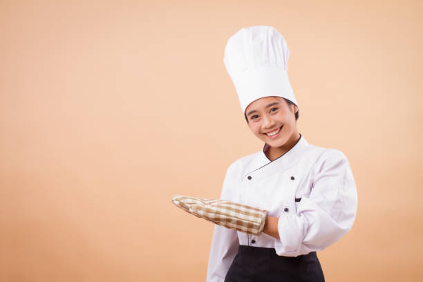 istock baker woman pointing up, mitten glove 1299941096