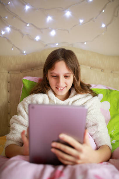 istock girl playing game with tablet 1299942317