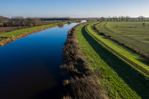 elevated view of river and flood barrier or levee