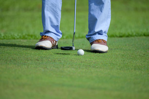 istock Golf club and ball in grass 1299944013