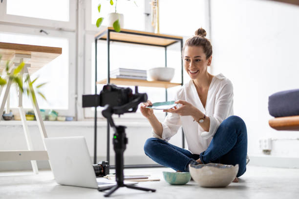 Female vlogger making social media video about her pottery Female vlogger making social media video about her pottery pottery photos stock pictures, royalty-free photos & images
