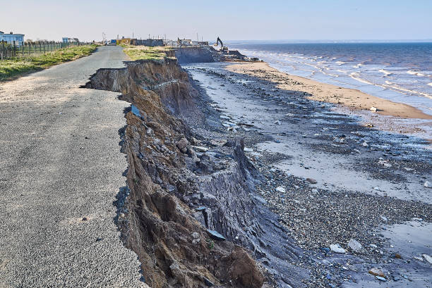 Coastal Erosion at Skipsea on the East Yorkshire Coast a roaded collapsing into the sea due to sea level rise on the Holderness coast -  Climate Change eroded stock pictures, royalty-free photos & images