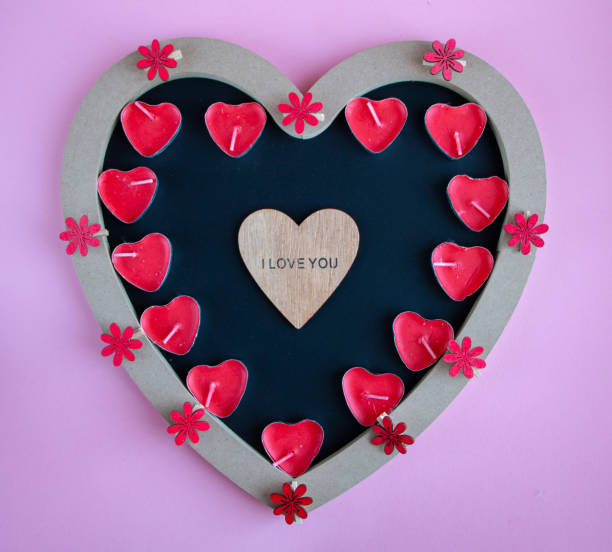 istock chalk board in shape of  heart for copying space or writing congratulation text, with various red and pink accessories in  shape of  heart, for  postcard or congratulations on Valentines Day 1299945593