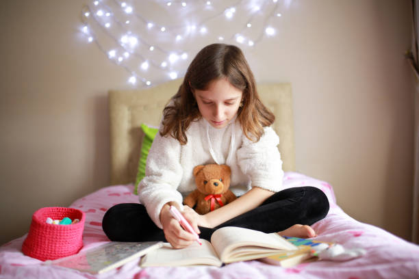 istock girl studying in her bed 1299946272