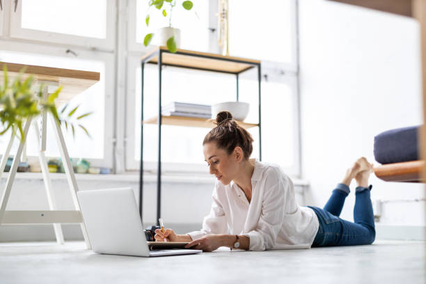 istock Creative young woman working on laptop in her studio 1299946467
