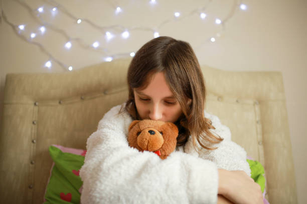 istock girl who loves her teddy bear 1299946573
