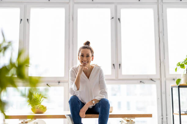 istock Portrait of a smiling creative woman in a modern loft space 1299946596