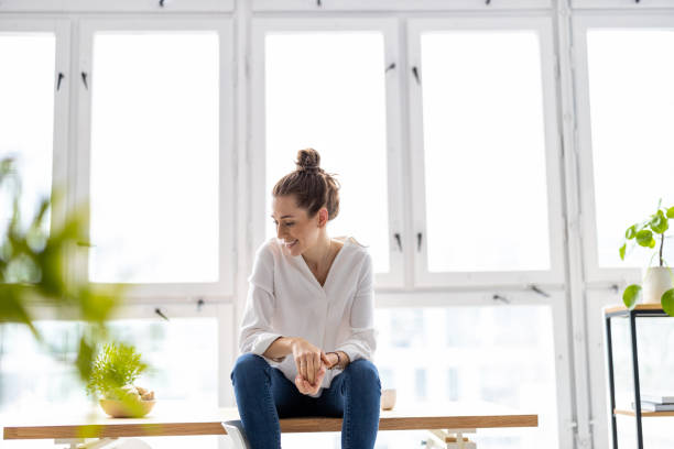 istock Portrait of a smiling creative woman in a modern loft space 1299946689